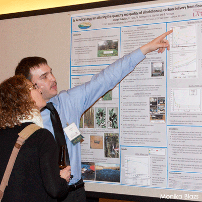 Man pointing to scientific poster