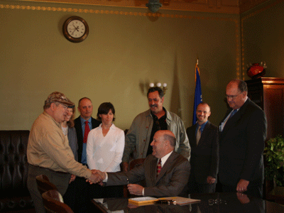 Lawmaker shaking hand with landowner Lawmaker shaking hand with landowner