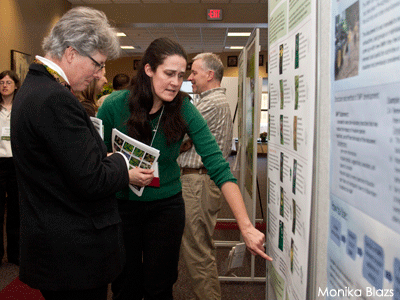 Woman pointing at wetland science poster