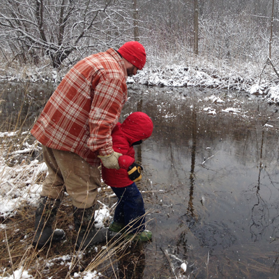 Man showing child a pond Man showing child a pond