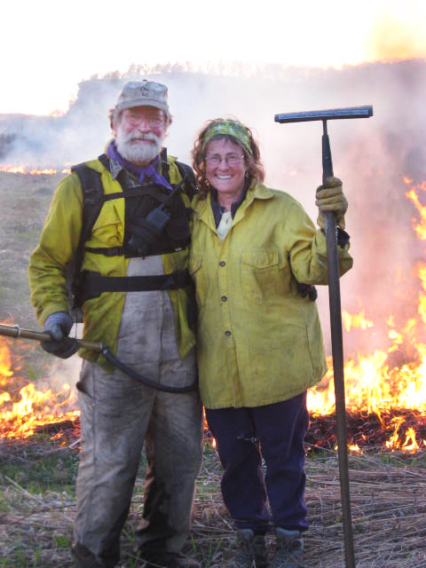 Landowners proudly pose in front of their successful prescribed burn.