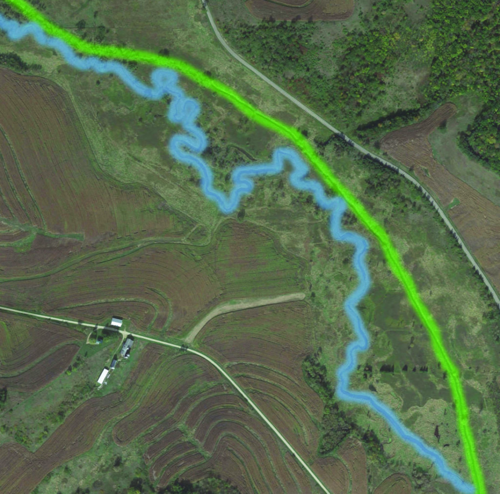 In this satellite view, you can see the linear ditch (highlighted in green) that follows the road on the right, as well as the winding original channel (highlighted in blue).